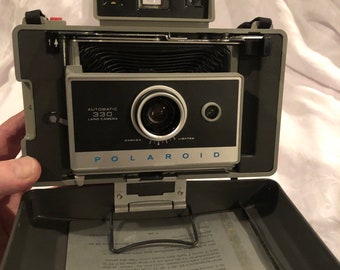 A vintage Polaroid c 1970s Automatic 330 land Camera.