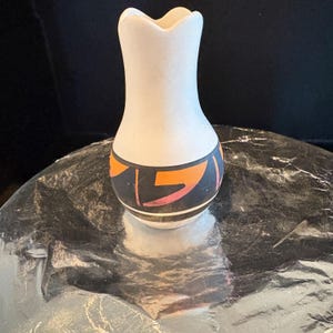 A vintage pottery wedding vase made in the , “Ute Mountain Ute Tribe” fashion  by the popular Ute artist Ruth Root who has signed the work.