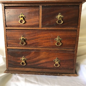 An Antique  Flamed Mahogany miniature chest of drawers c1895, preowned and professionally polished in very presentable condition..