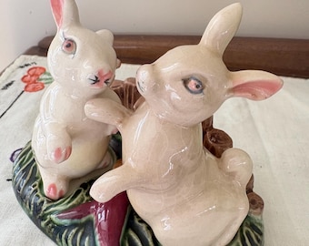 A made in USA cruet set of 2 rabbits sitting on a woodland plinth between a carrot, preowned in excellent condition all hand painted.