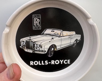 A vintage 3 place ashtray advertising a Rolls Royce Luxury 2 door Convertible Cornish. The preowned ashtray is excellent display condition.