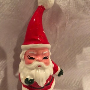 A Vintage c 1960s Christmas ornament in the form of a vintage Santa made in Japan, preowned in good condition.