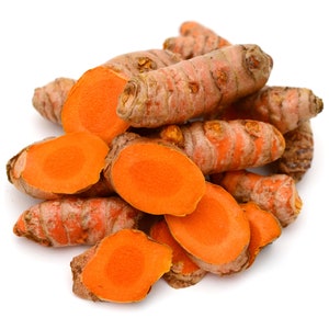 May include: A pile of turmeric root, some whole and some sliced, showing the bright orange flesh inside.