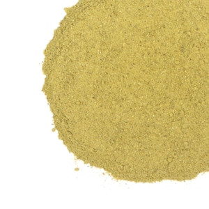 May include: A close-up of a pile of light green dried herbs. The herbs are finely ground and have a powdery texture.