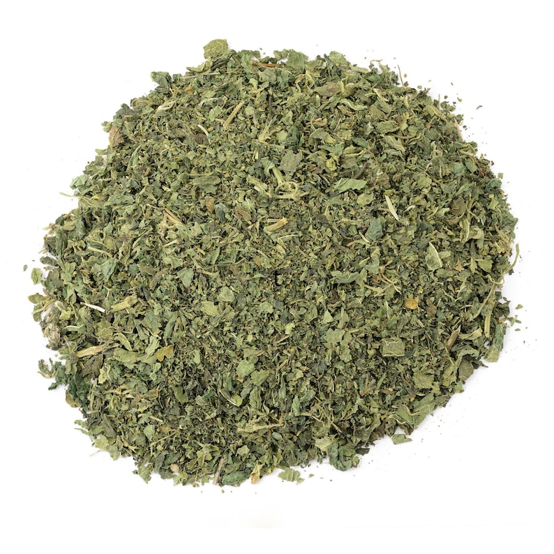 May include: A pile of dried green nettle leaves, a popular herb used in teas and cooking.