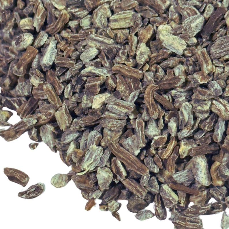 May include: Close-up of dried, chopped burdock root. The root pieces are a mix of brown and green, with a rough, fibrous texture.