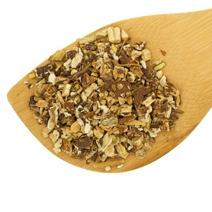 May include: A wooden spoon filled with dried, chopped, light brown and beige herbal roots.