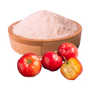 May include: A wooden bowl filled with white powder, surrounded by four red acerola cherries. One cherry is cut in half, revealing the yellow flesh.
