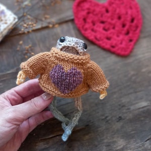 Knitted Froggie wearing sweater with hand-embroidered detailing