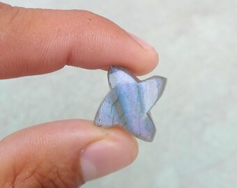 May include: A star-shaped labradorite gemstone with iridescent blue and green hues.