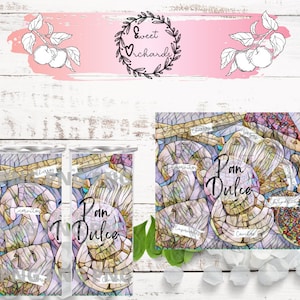 May include: Two stainless steel tumblers with a stained glass design featuring the words "Pan Dulce" in a colorful font. The tumblers are surrounded by ice and a green leaf.