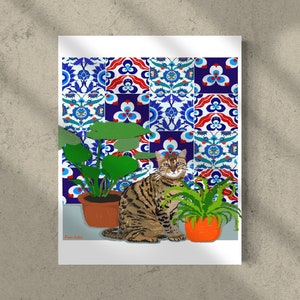 May include: A brown tabby cat sits in front of a wall with colourful patterned tiles. The cat is looking directly at the viewer. There are two potted plants on either side of the cat.