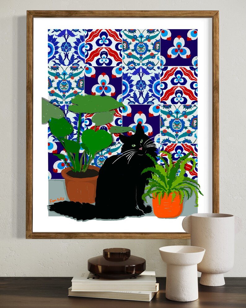 May include: A black cat sits in front of a wall covered in colourful patterned tiles. The cat is looking at the viewer. There are two potted plants in the image, one with green leaves and one with long, thin green leaves.