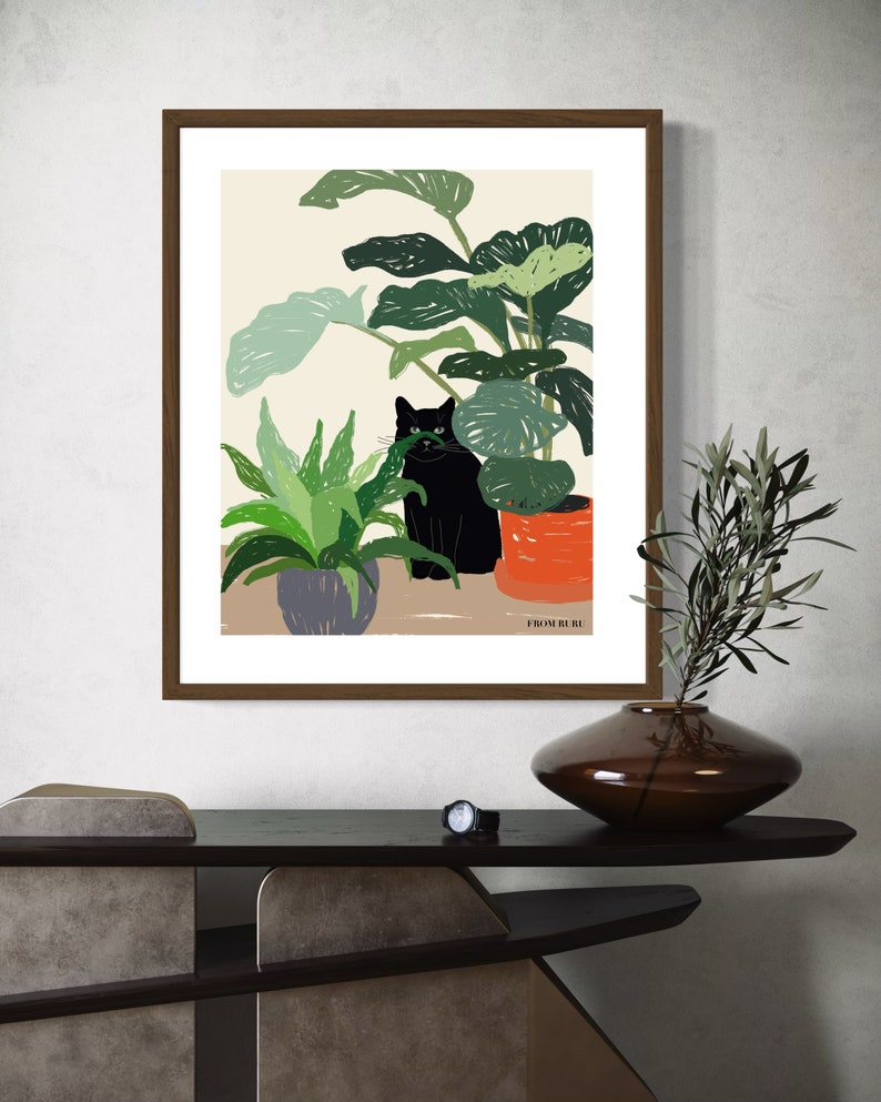 May include: A framed illustration of a black cat sitting in front of a potted plant. The cat is looking at the viewer. The illustration is on a beige background with the text "From Ruri" at the bottom.