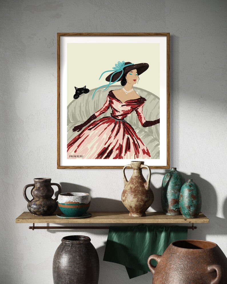 May include: A framed illustration of a woman in a red and white dress with a blue hat and a black cat sitting on a couch. The text "#FROM RURU" is at the bottom of the image.