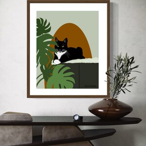 May include: A black and white cat with green eyes is lying on a green platform with a brown arch behind it. Green leafy plants are in the background. The text "FROM RURI" is at the bottom of the image.