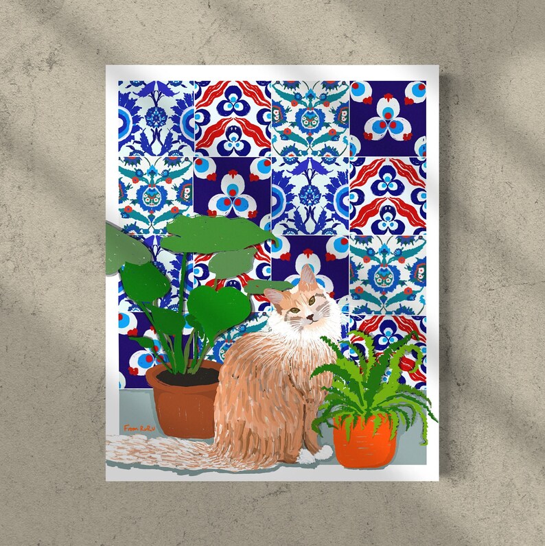 May include: A ginger cat with white fur sits in front of a wall with blue and red patterned tiles. The cat is looking at the camera. There are two potted plants in the image, one with large green leaves and the other with small green leaves. The text "From Kiki" is written in the bottom left corner of the image.
