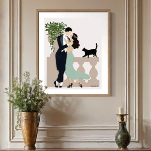 May include: A framed illustration of a couple dancing on a balcony with a black cat watching them. The man is wearing a tuxedo and the woman is wearing a green dress. The illustration is set against a light brown background.