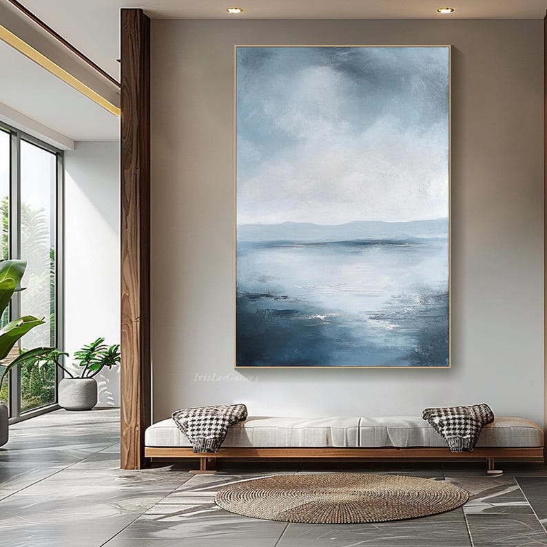 May include: Abstract painting of a seascape with a blue and white color scheme. The painting depicts a calm body of water with a distant horizon and a cloudy sky.