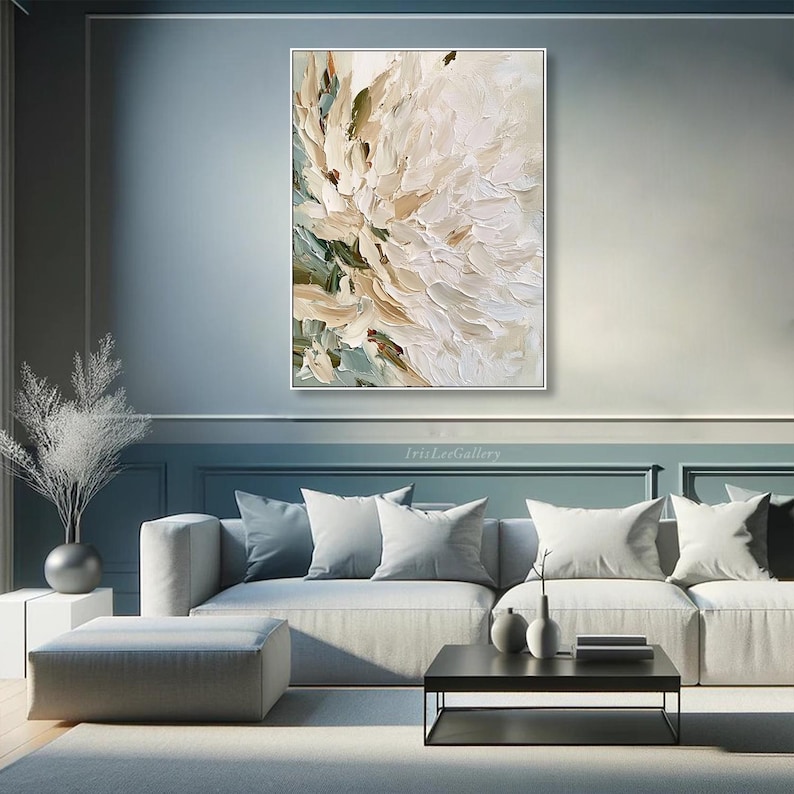 May include: A rectangular wall art piece featuring an abstract floral painting with thick, textured impasto brushstrokes in shades of cream, white, beige, and muted sage green, displayed in a thin white frame on a blue wall.