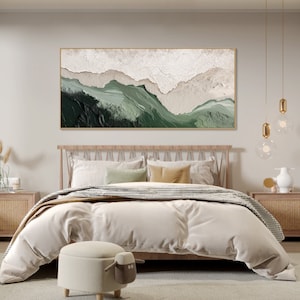 May include: A bedroom with a wooden bed frame and a white duvet. The bed has a green and white abstract painting above it. The painting is framed in gold. There are two nightstands on either side of the bed.