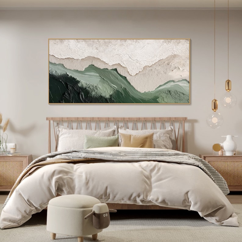 May include: A bedroom with a wooden bed frame and a white duvet. The bed has a green and white abstract painting above it. The painting is framed in gold. There are two nightstands on either side of the bed.