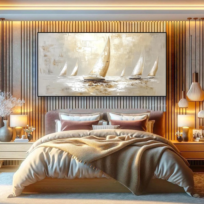 May include: A large framed canvas painting of sailboats on the water in beige, white, and brown tones. The artwork hangs above a bed with a beige duvet and decorative pillows. The room features warm lighting and wooden accents.