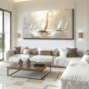May include: Abstract painting of sailboats in neutral tones. The artwork depicts several sailboats with white sails against a light background. The painting hangs above a white sectional sofa in a modern living room setting.