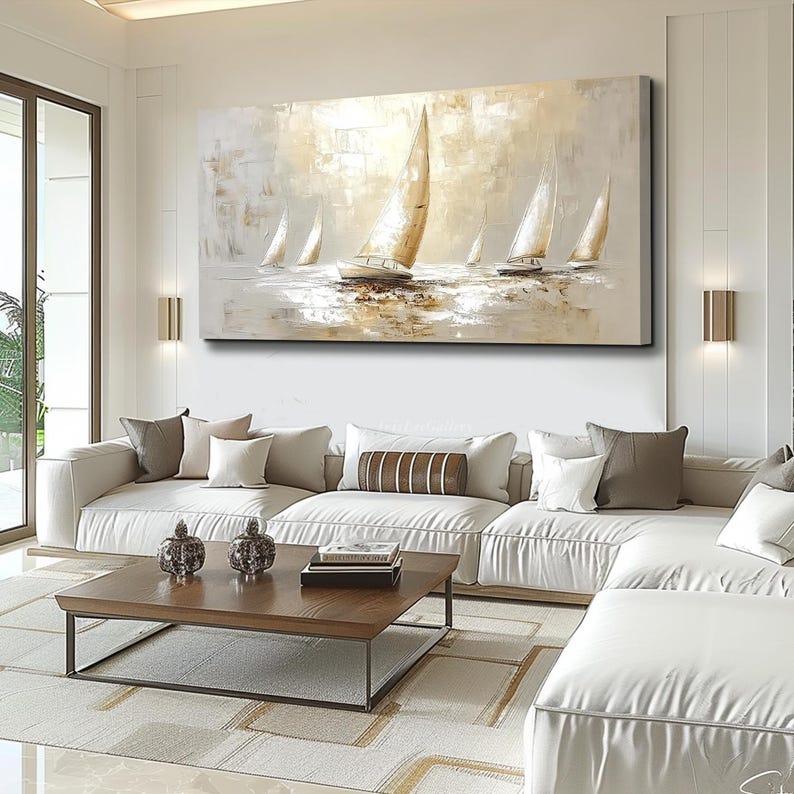 May include: Abstract painting of sailboats in neutral tones. The artwork depicts several sailboats with white sails against a light background. The painting hangs above a white sectional sofa in a modern living room setting.