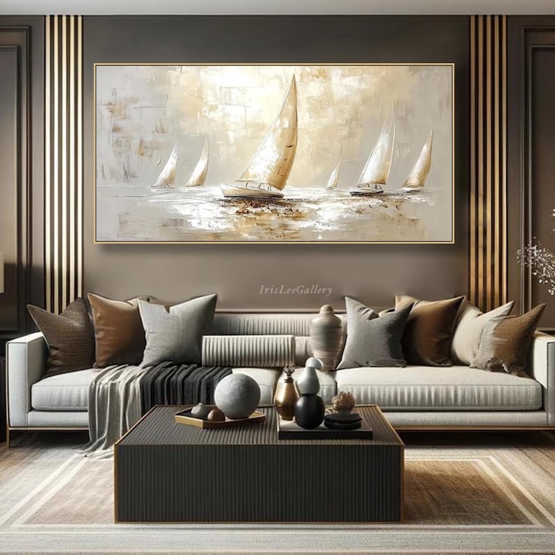 May include: An abstract oil painting of sailboats on the water in neutral tones. The artwork features several white sailboats with beige sails, set against a backdrop of soft beige and grey hues. The painting is framed in a gold-coloured frame.