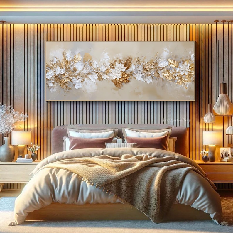 May include: A large rectangular canvas art piece featuring a floral design with gold and white textured elements. The artwork is displayed above a bed with a neutral color palette, creating a serene and elegant bedroom setting.