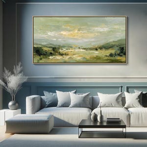 May include: An abstract landscape painting in a gold frame. The artwork features a serene scene with rolling hills, trees, and a cloudy sky. The color palette includes shades of green, yellow, and white, creating a calming and natural aesthetic.