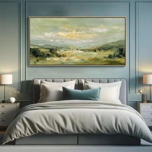 May include: An abstract landscape painting in a gold frame hangs above a bed. The artwork features a palette of greens, yellows, and whites, depicting a serene countryside scene. The bed is made with white pillows, a teal bolster pillow, and a gray comforter.