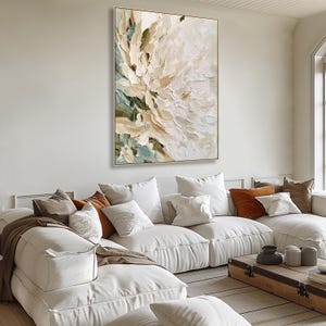 May include: A large rectangular canvas painting featuring thick, textured impasto brushstrokes in shades of cream, white, beige, and muted sage green. The abstract floral composition displays layered paint application, creating a three-dimensional effect across the surface of the artwork.