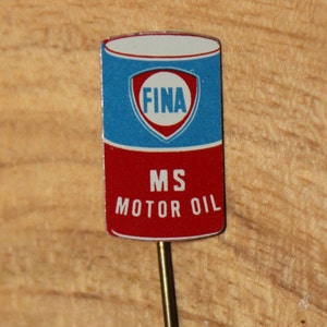 May include: A rectangular pin with a blue and red design. The top portion is blue with a white and red emblem that reads "FINA". The bottom portion is red with the text "MS MOTOR OIL". The pin has a gold-colored metal stem.