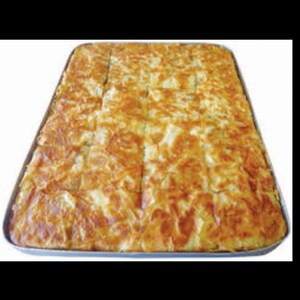 May include: A large rectangular pan filled with a golden brown baked pastry, cut into squares. The pastry has a flaky, layered texture.