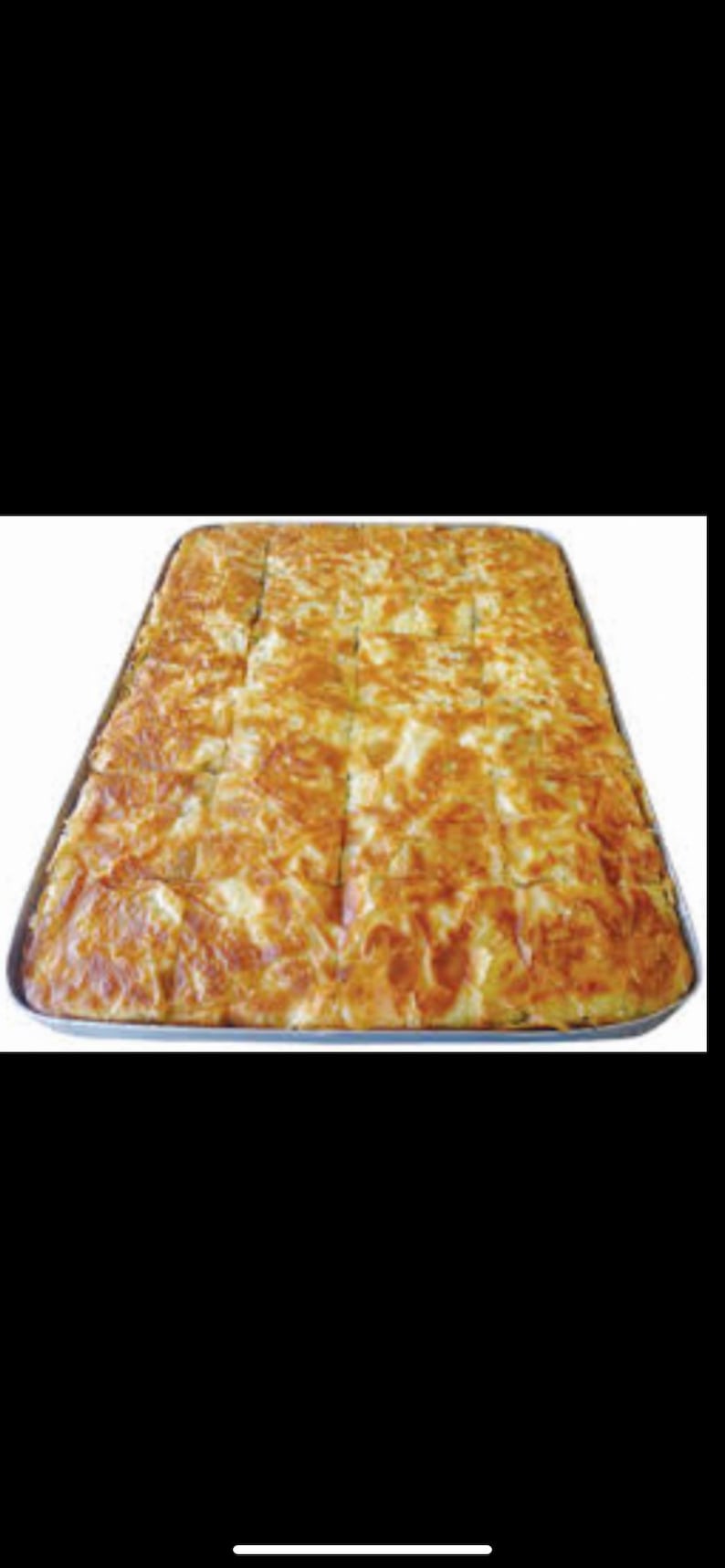 May include: A large rectangular pan filled with a golden brown baked pastry, cut into squares. The pastry has a flaky, layered texture.