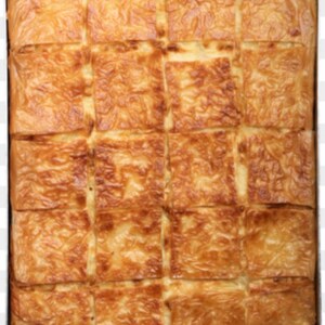 May include: A large tray of golden brown baked pastry squares, cut into even pieces, ready to be served.