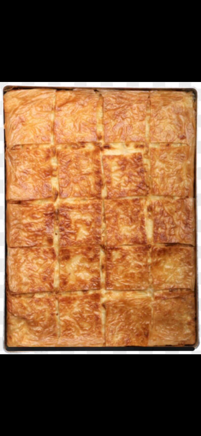 May include: A large tray of golden brown baked pastry squares, cut into even pieces, ready to be served.