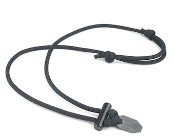 May include: A black paracord necklace with a black metal fire starter pendant. The pendant has a small, sharp blade on one side and a small, round knob on the other side.