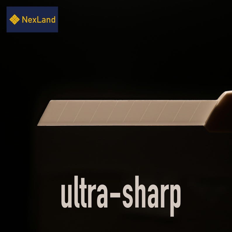 May include: A close-up of a beige utility knife blade with the text "ultra-sharp" in white. The blade has several parallel lines. The NexLand logo is in the upper left corner. The background is black.