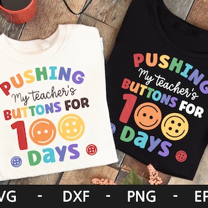 May include: Two white t-shirts with a rainbow design and the text "Pushing my teacher's buttons for 100 days".