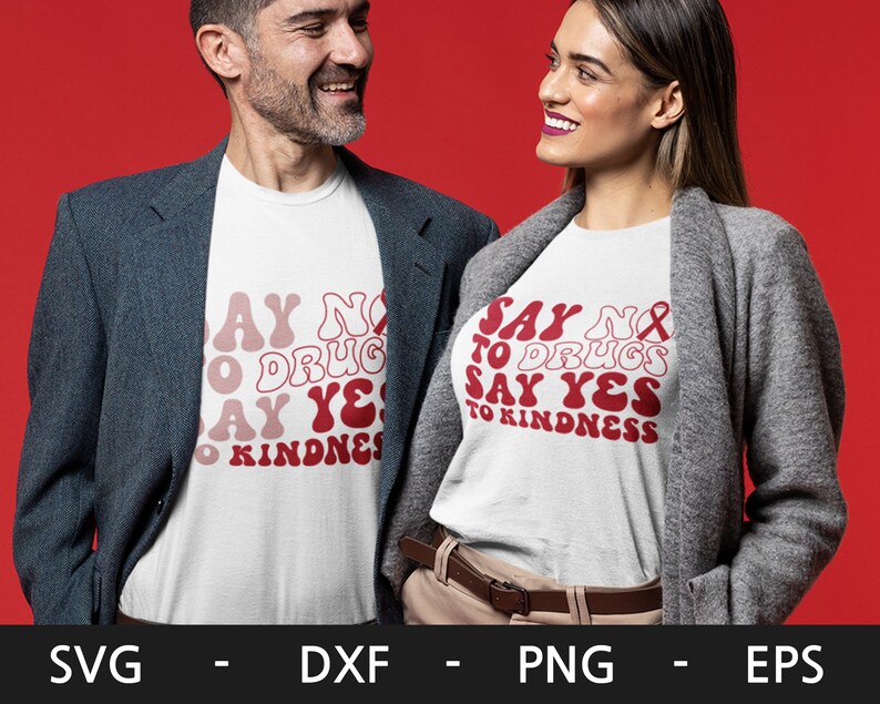 May include: Two people wearing white t-shirts with red text that says "Say No to Drugs Say Yes to Kindness". The text is in a retro font style. The people are wearing casual clothing and are standing against a red background.