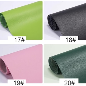 May include: Four samples of faux leather in different colors: green, black, pink, and dark green. Each sample is rolled up and labeled with a number.