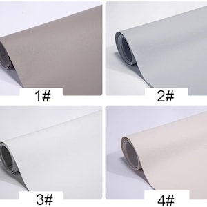 May include: Four rolls of faux leather in different colors: gray, light gray, white, and off-white. The rolls are labeled 1# through 4#.