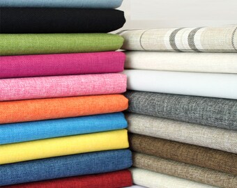 May include: A stack of fabric swatches in various colors and textures, including blue, black, green, pink, orange, yellow, red, and brown. The fabrics are arranged in a vertical stack, with the lighter colors at the top and the darker colors at the bottom.