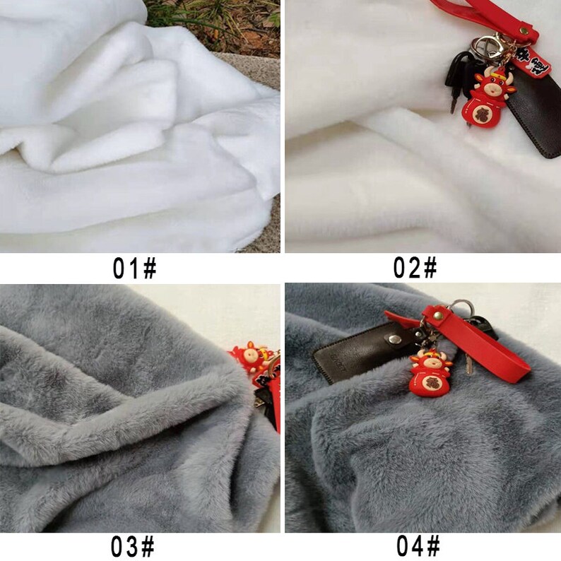 May include: Four fabric swatches, two white and two gray. The white swatches are smooth and the gray swatches are fuzzy. The top two swatches have a red and gold keychain with a small red ox charm.