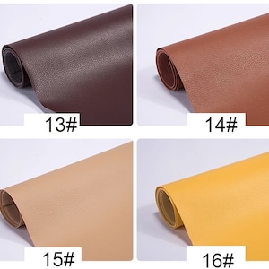 May include: Four samples of faux leather in different colors: brown, dark brown, beige, and yellow. Each sample is rolled up and labeled with a number.