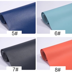 May include: Four samples of faux leather in different colors: dark blue, light blue, dark gray, and coral. Each sample is rolled up and labeled with a number.