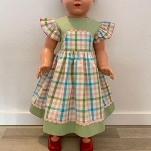 Springy, colorful checkered dress with pastel green details for Schildkröt doll, size. 46-70